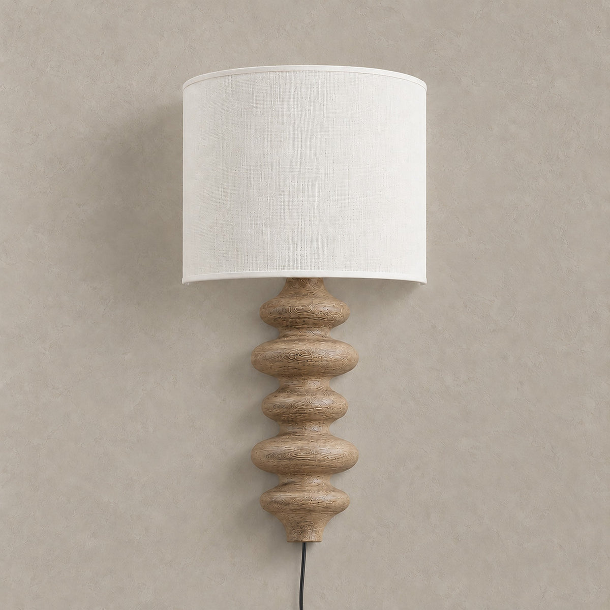 Nalimor wood color plug in wall sconce with linen shade on a plain backdrop #color_wood color