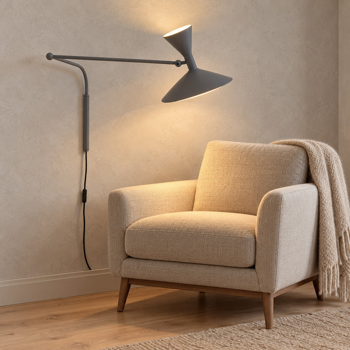 Nalveto gray wall sconce with a tilted head casting light over a den chair #color_gray