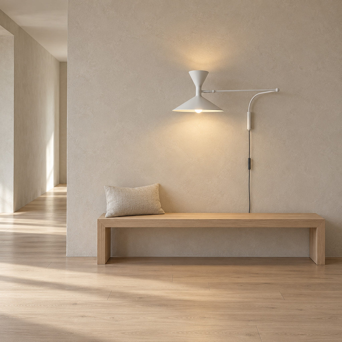 Nalveto white plug in wall sconce lit above a hallway bench by day, its cord dropping behind the bench