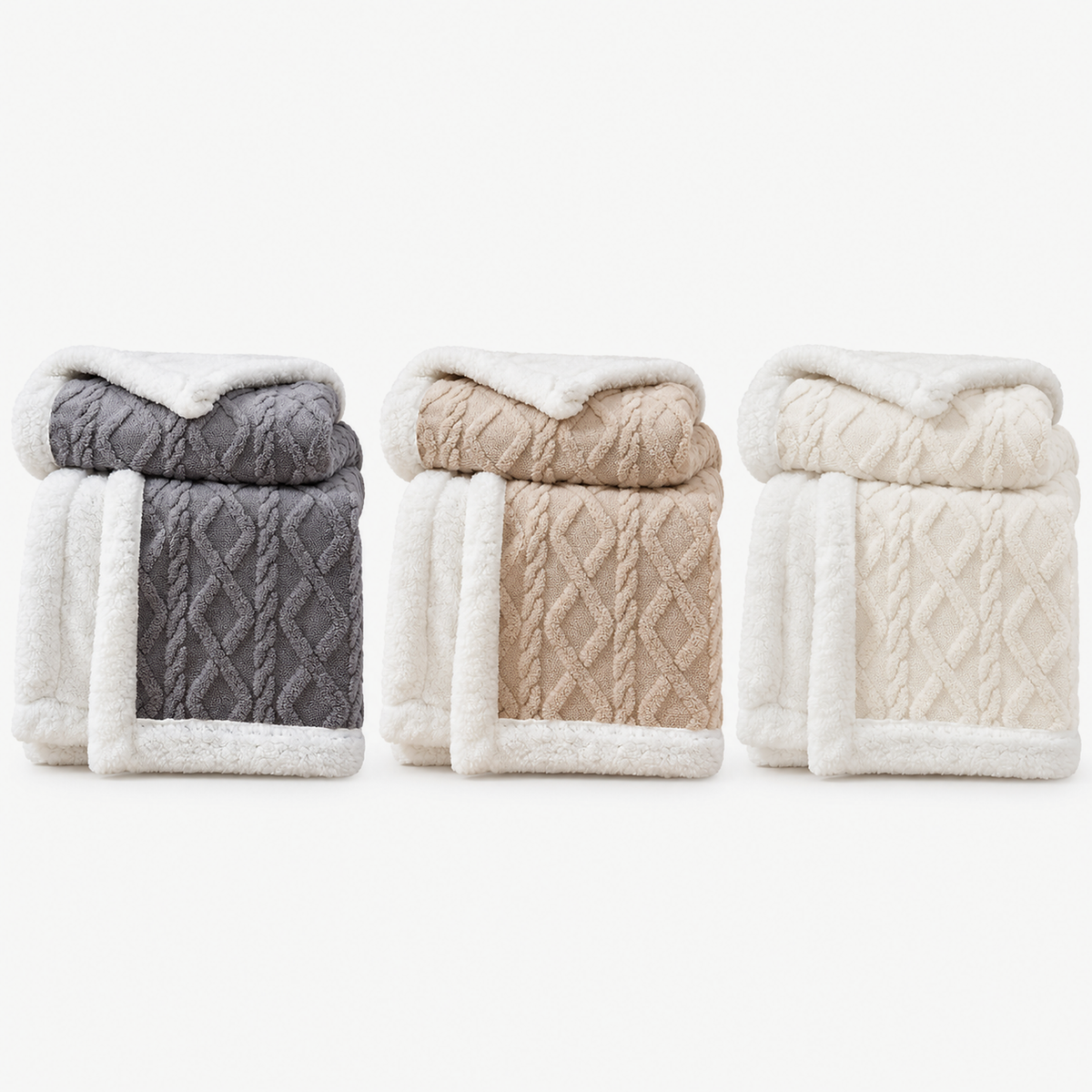 Narelvo charcoal, latte and creamy white plush throw blankets folded together to compare the colors