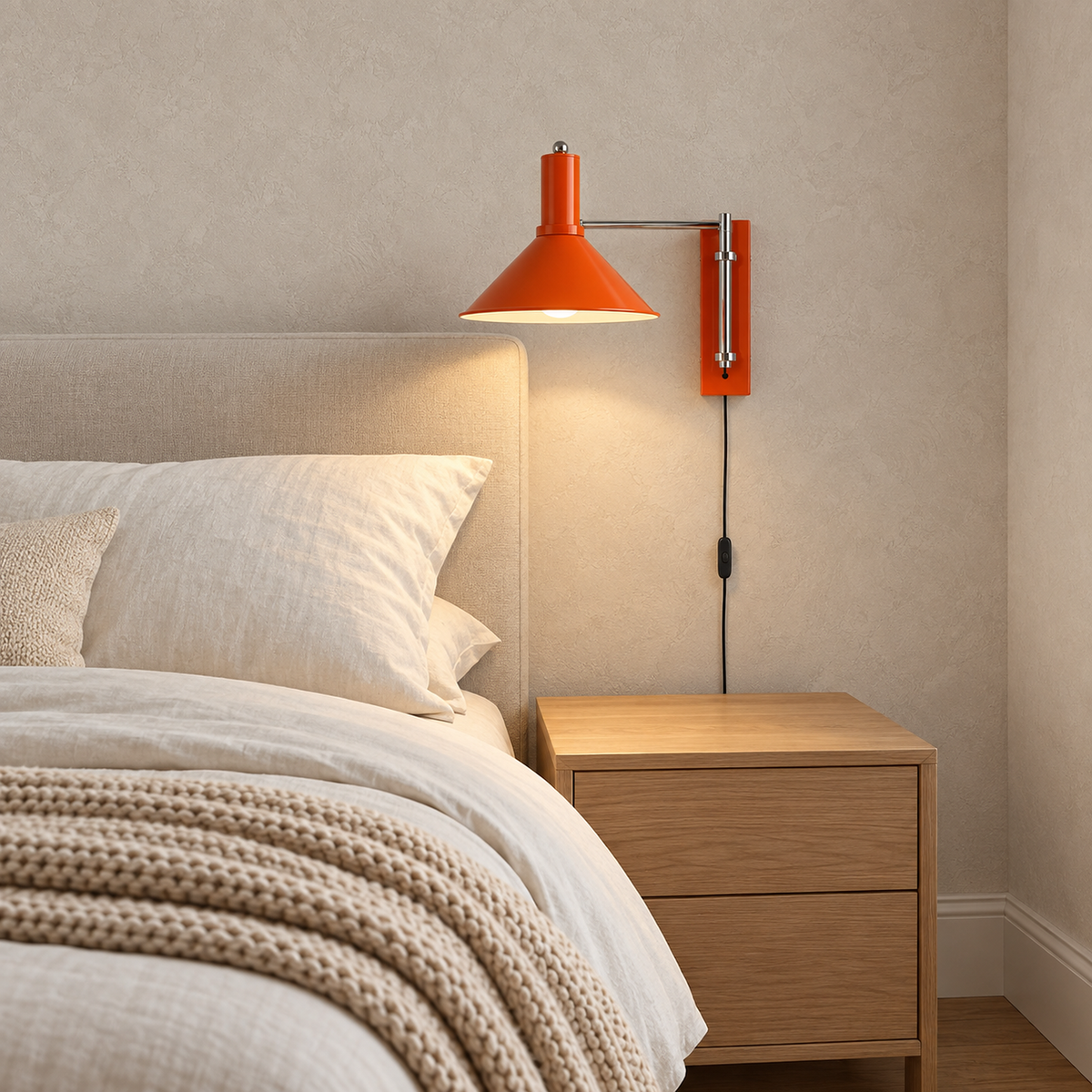 Navellir orange bedside lamp lit above a clear bedside cabinet in the guest bedroom #color_orange