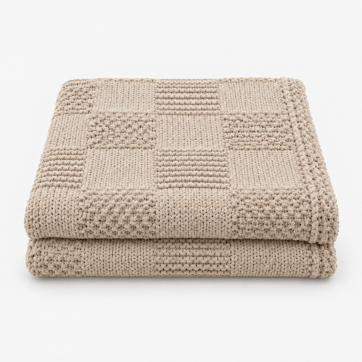Nelvari beige checkered knit throw blanket folded loosely and shown on white #color_beige