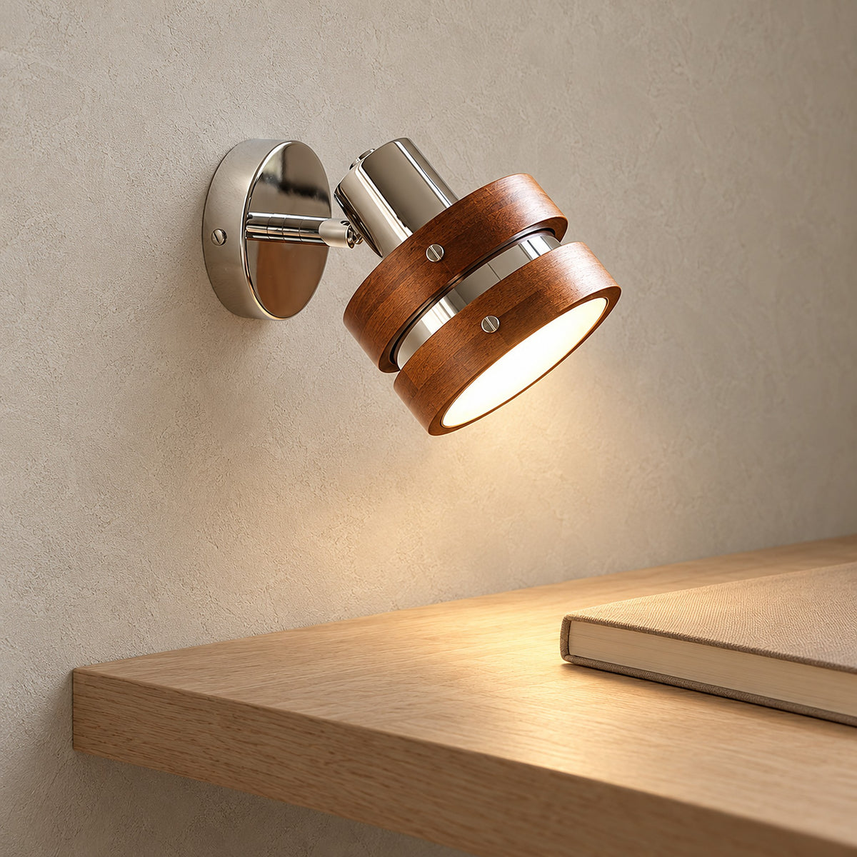 Nerilvo chrome and walnut bedside wall light showing the round shade opening with a warm glow