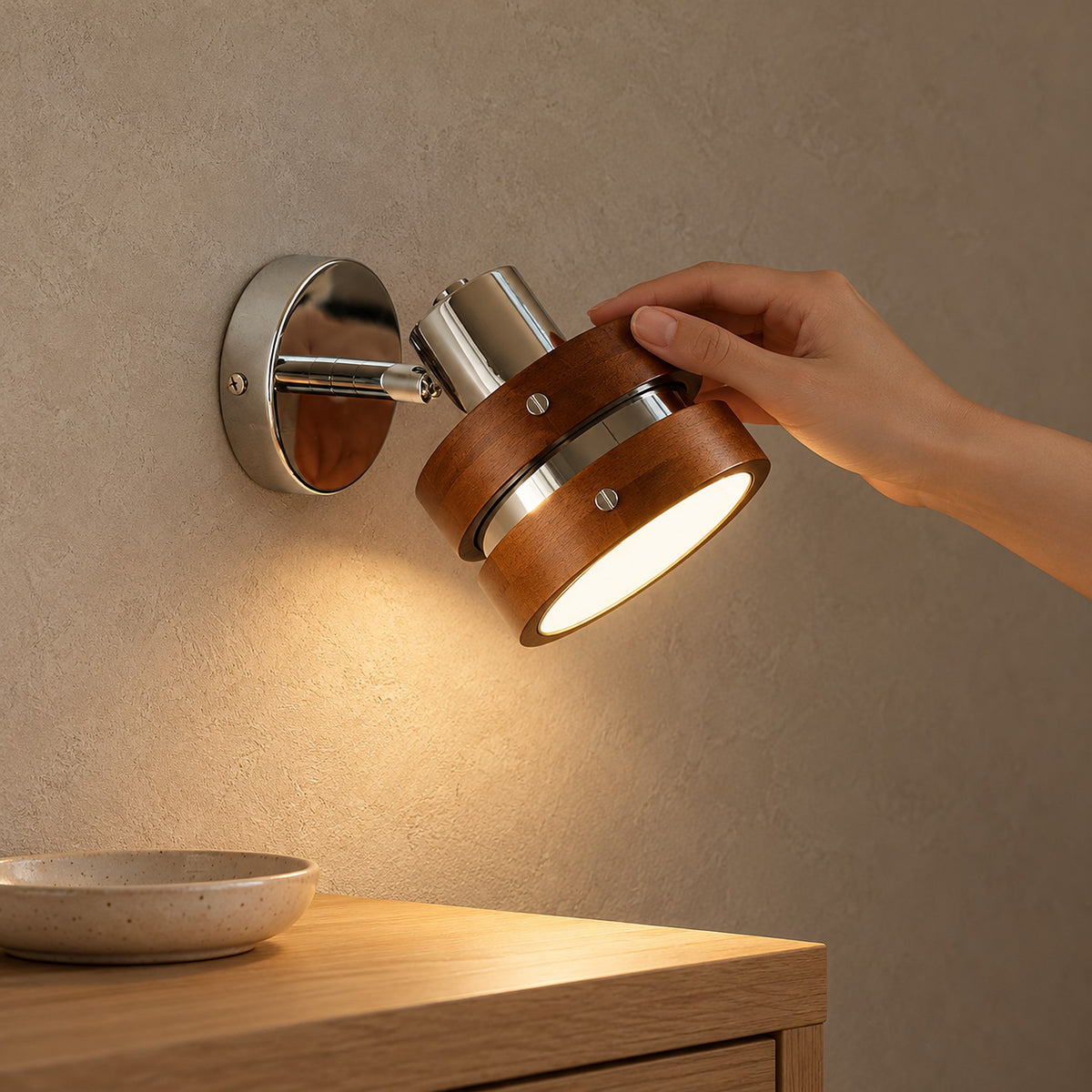 Nerilvo chrome and walnut wall sconce detail of the short arm and round 10cm backplate