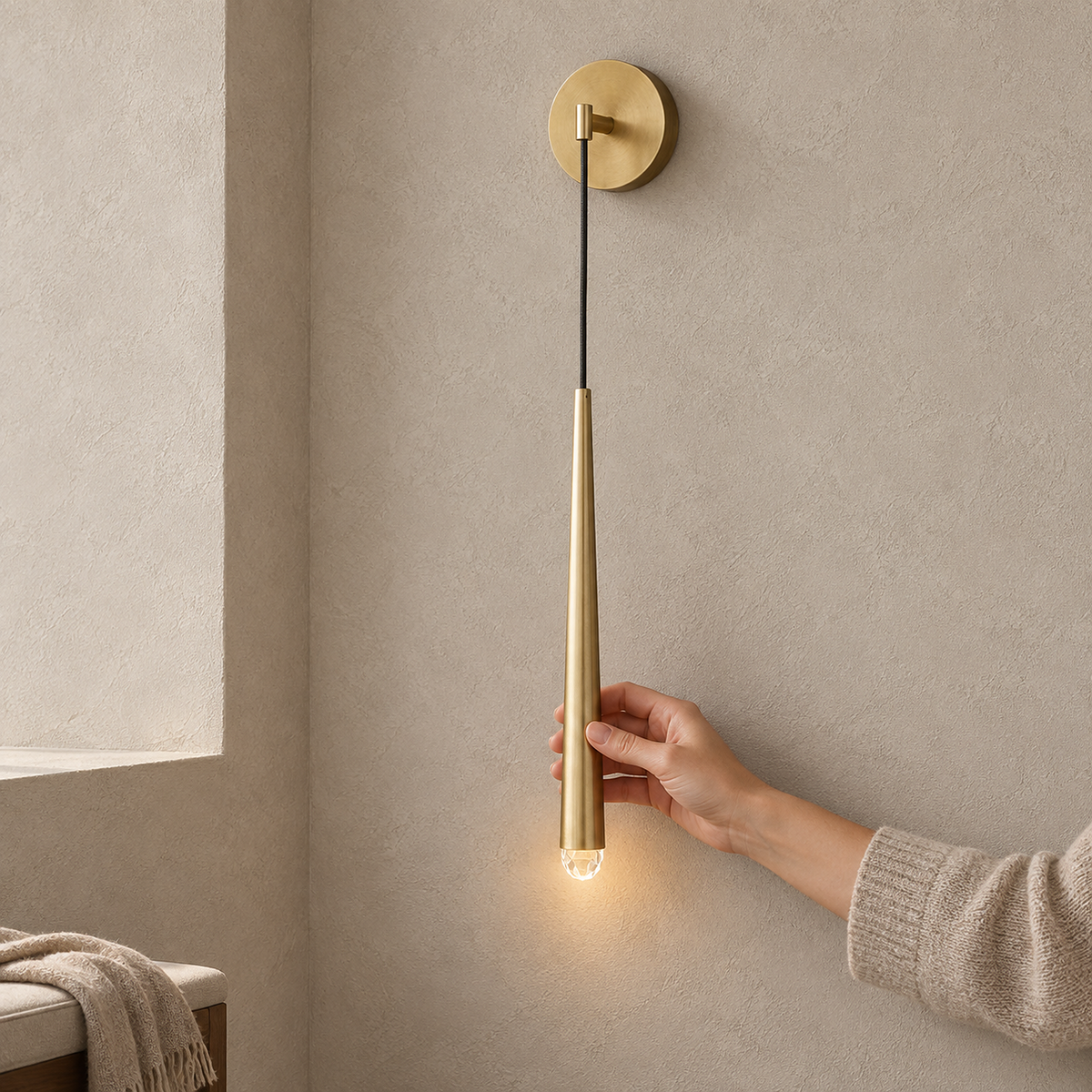 Nerisavo polished brass wall sconce lit in an entry vestibule during the day