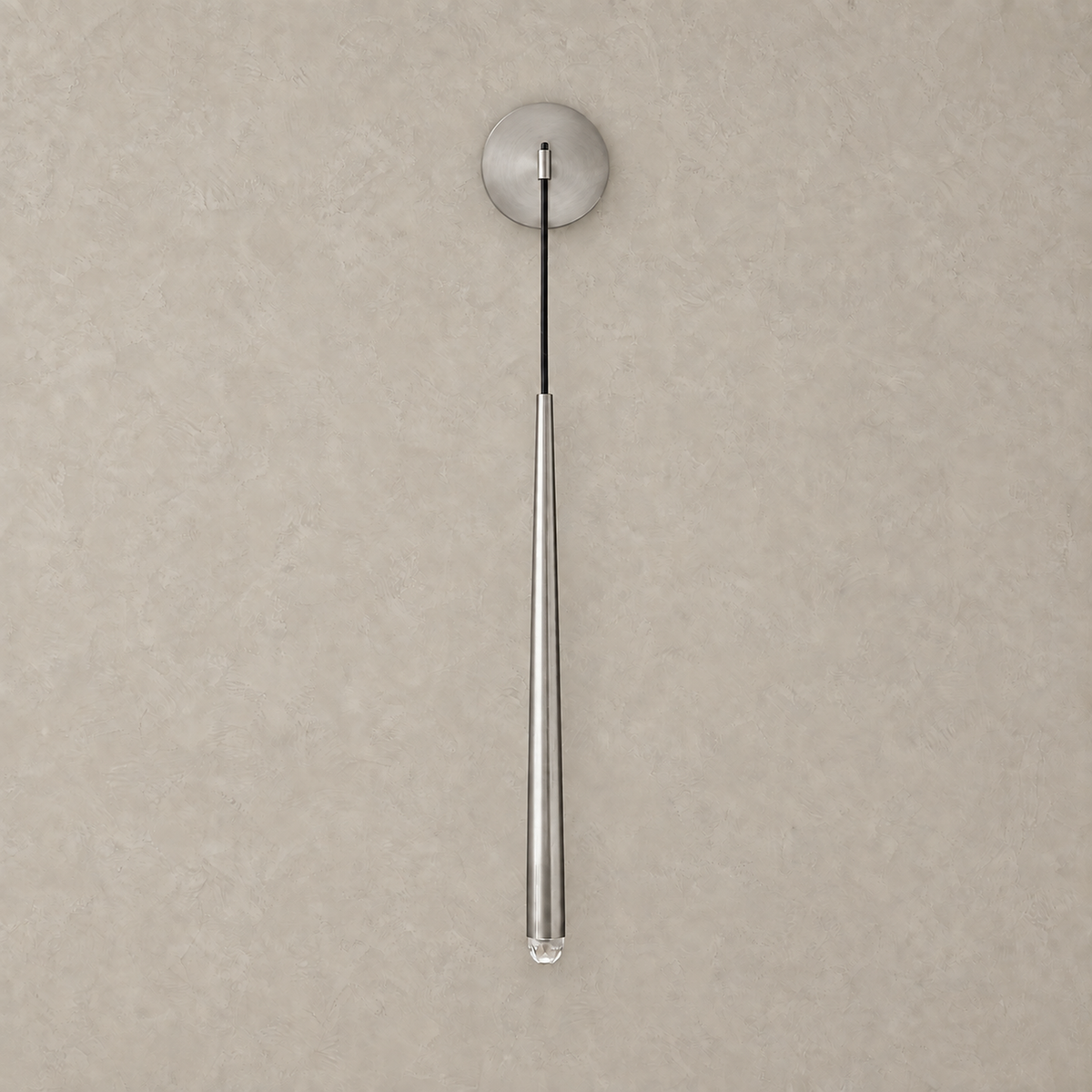 Nerisavo silver hanging wall sconce unlit on a plain backdrop, brass body with a crystal tip #color_silver