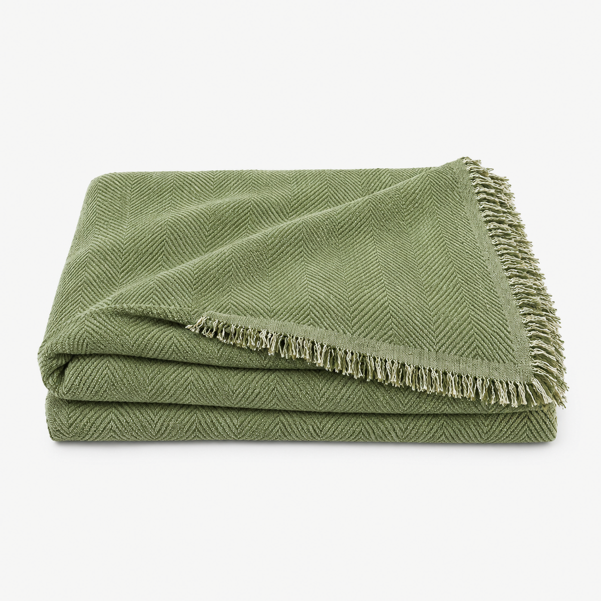 Nesolira green chenille sofa throw blanket loosely folded with its tassel fringe trim