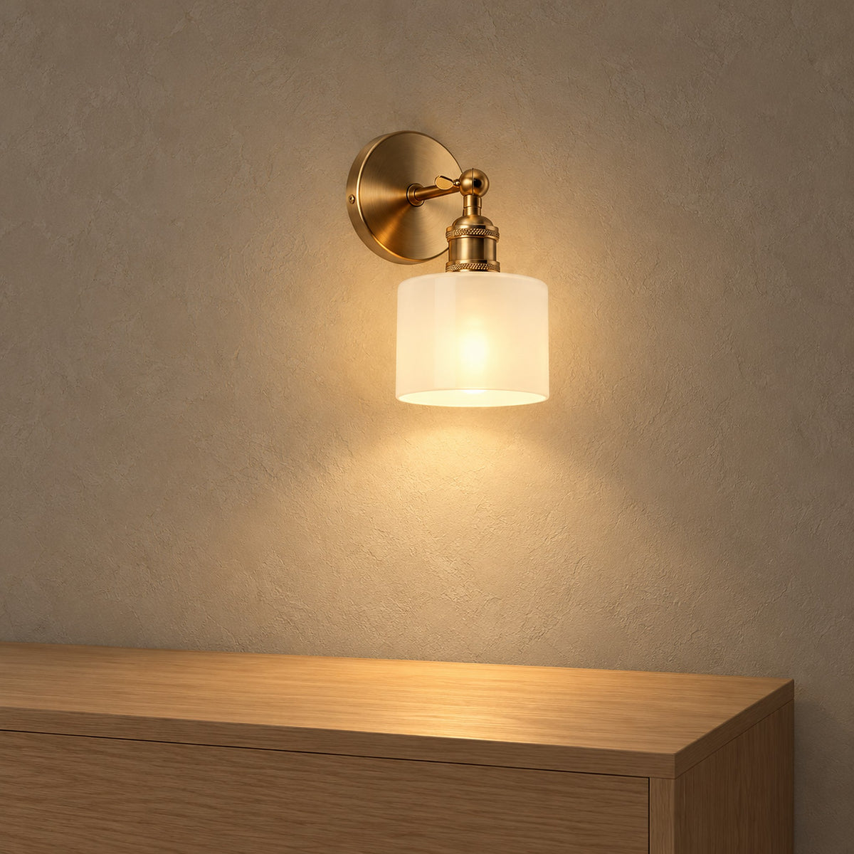 Nevalto White wireless wall light with brass coloured hardware glowing above an empty wooden console