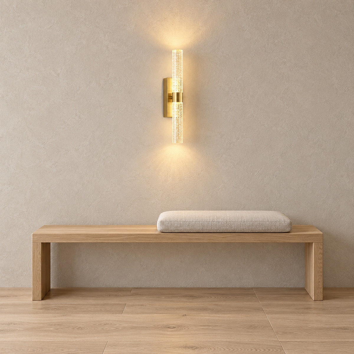 Nimarlo gold cordless wall lamp lit above an entry bench in a bright entryway