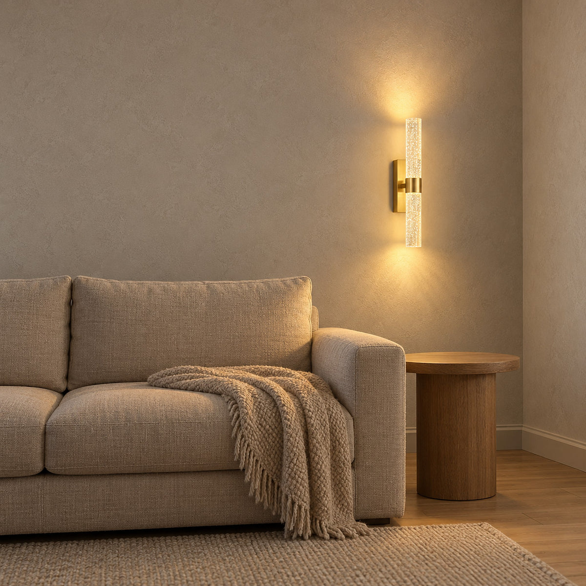 Nimarlo gold wireless wall light beside a sofa and an empty side table in a living room
