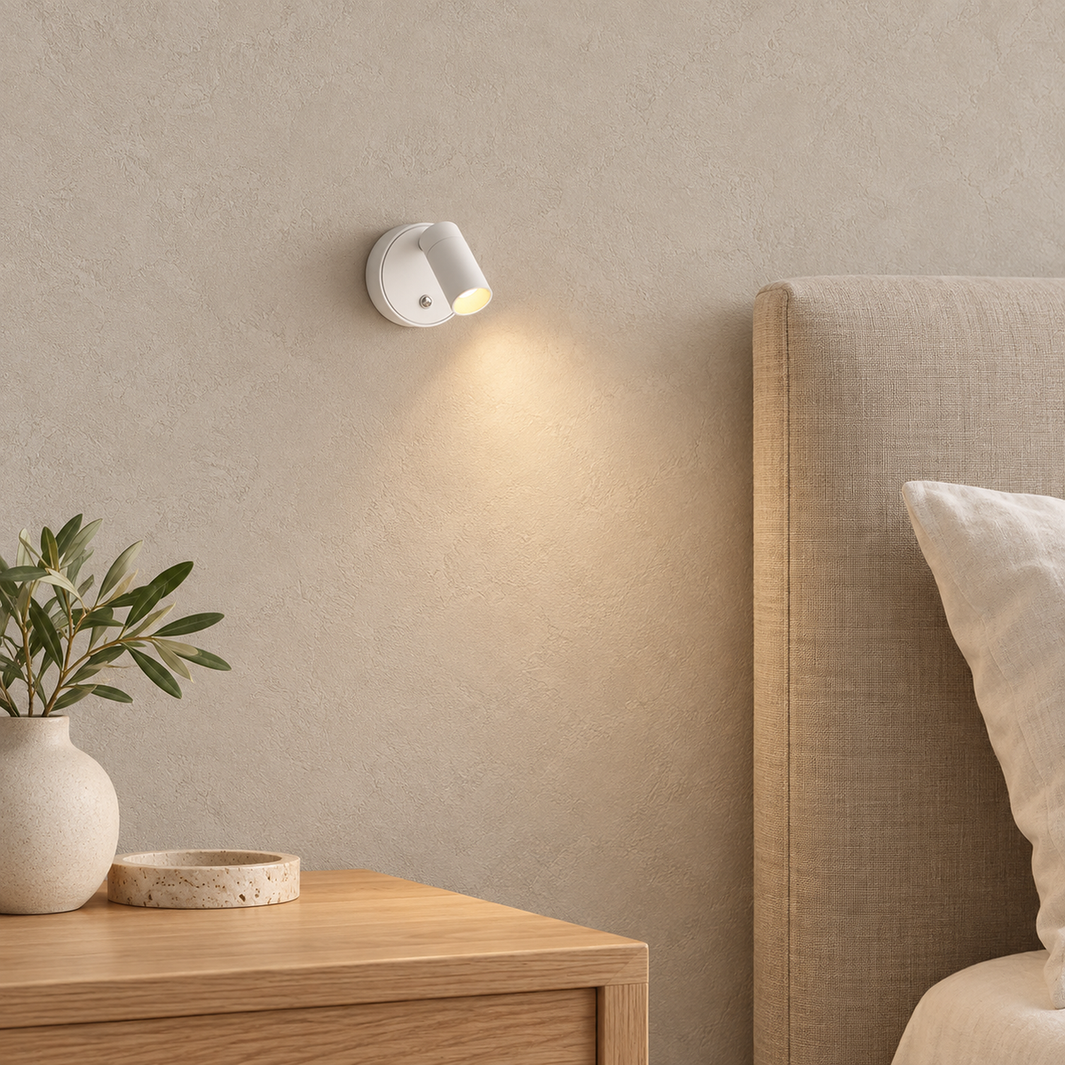 Nocarel white bedside lamp switched on above a clear pale tabletop corner in a bedroom #color_white
