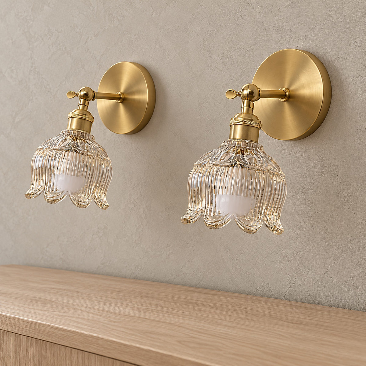 Pair of Nolavire golden battery operated wall sconces with clear glass shade on an entryway wall