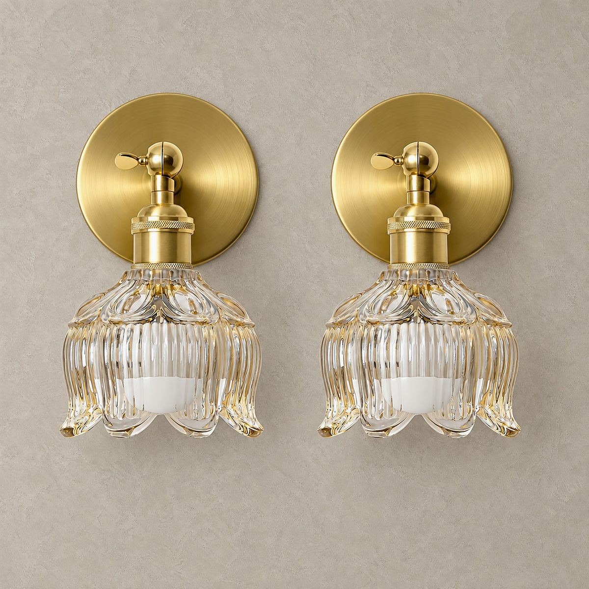 Pair of Nolavire golden rechargeable wall sconces with a round backplate and an unlit scalloped clear glass shade