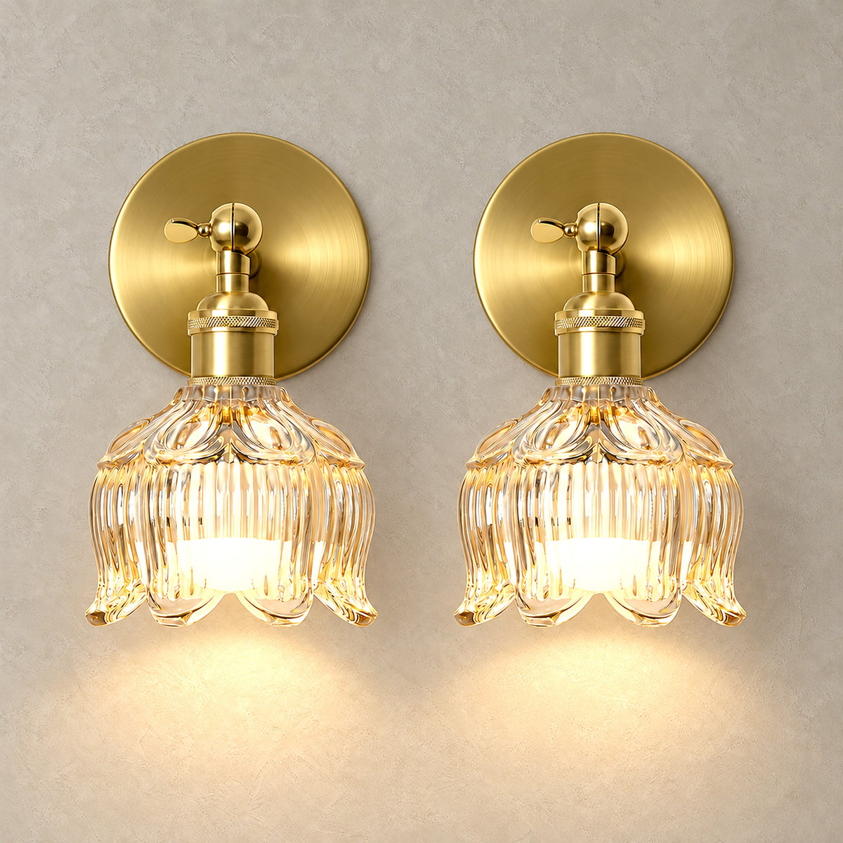 Pair of Nolavire golden led wall sconces lit up with light shining through every rib of the clear glass shade