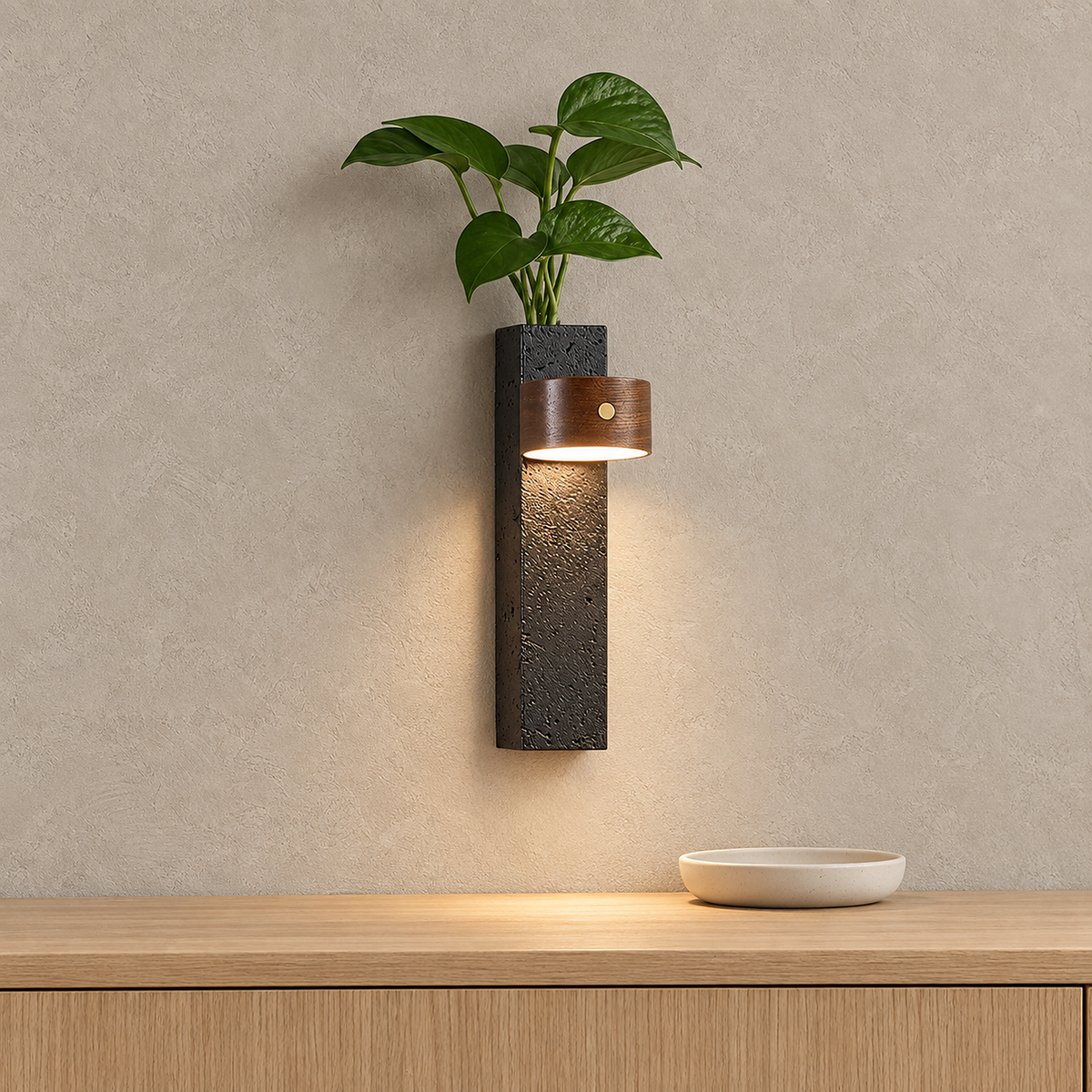 Nuvelira wireless wall light in dark walnut & black travertine casting warm light above an entry console