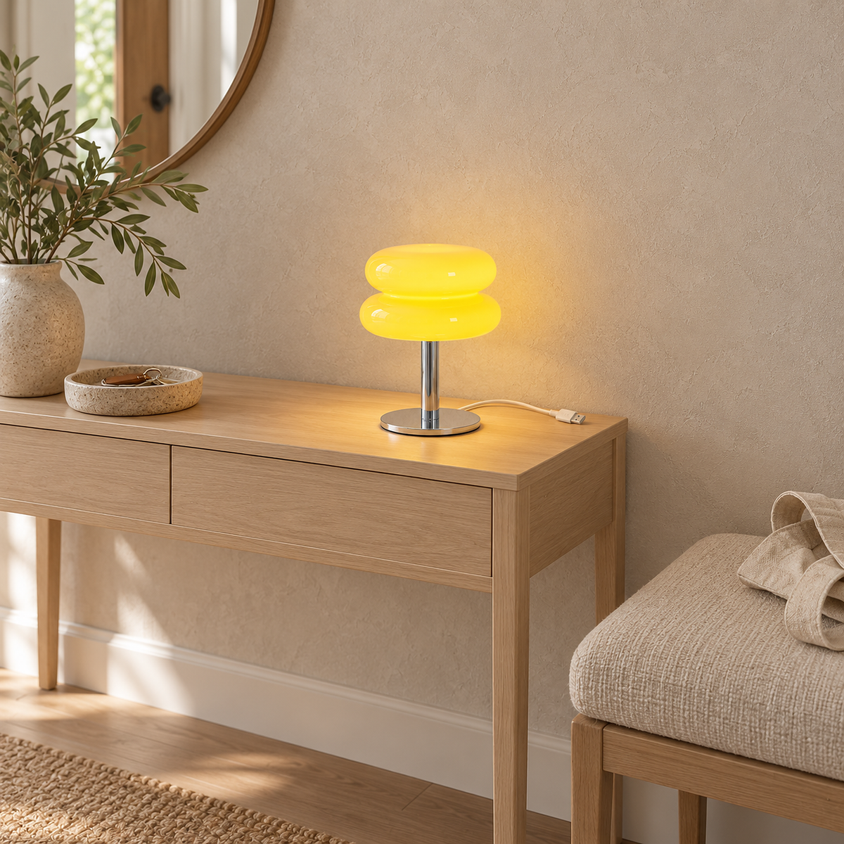 Olimena bedside lamp in buttercream glowing on a small entry console in daylight #color_buttercream