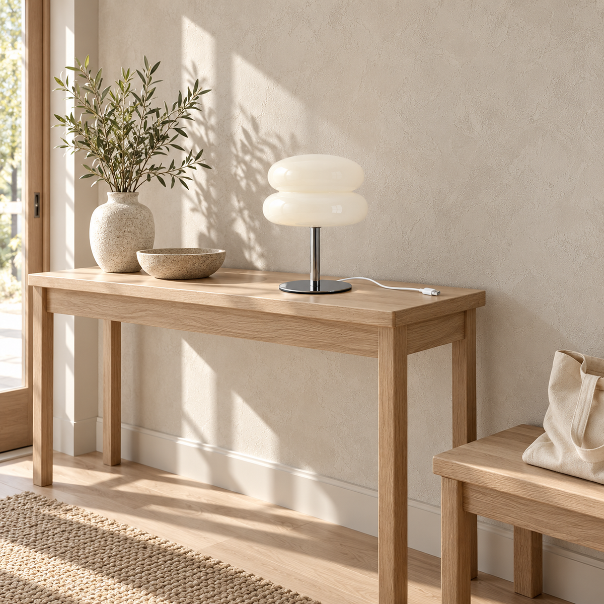 Olimena bedside lamp in pearl, unlit on a small sunlit entry console