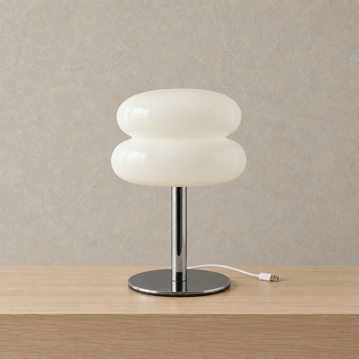 Olimena glass table lamp in pearl, unlit against a plain plaster wall with its glossy glass shade and iron base