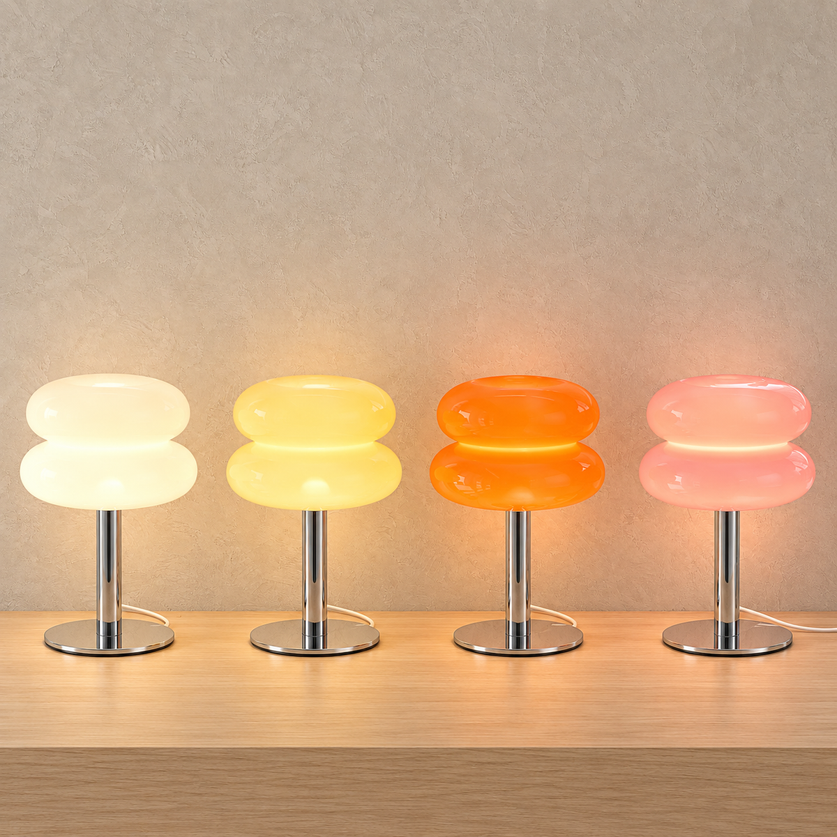 Olimena table lamps in pearl, buttercream, orange and blush glowing together side by side