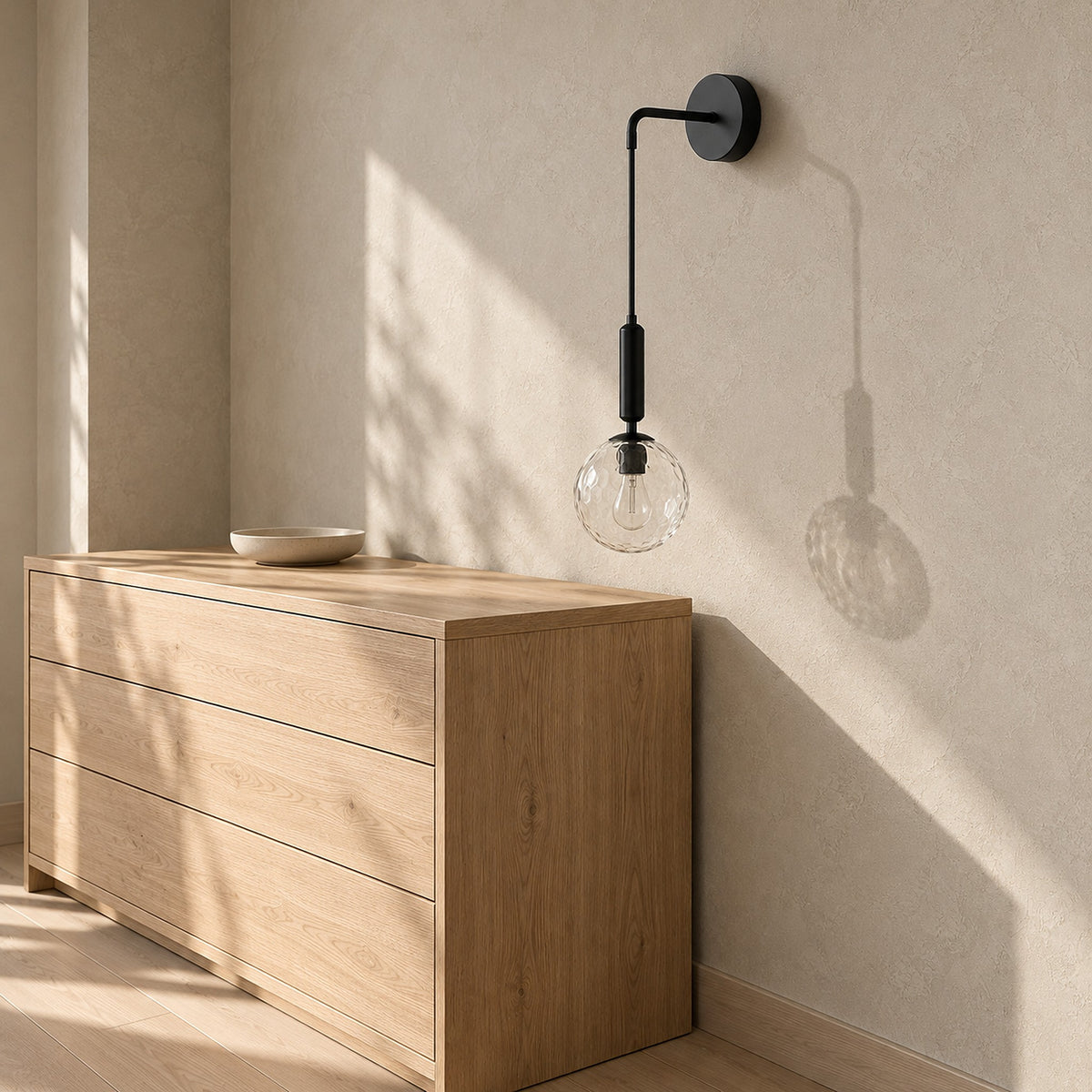 Orlamen black wall lamp switched off beside a sunlit dresser in a dressing alcove