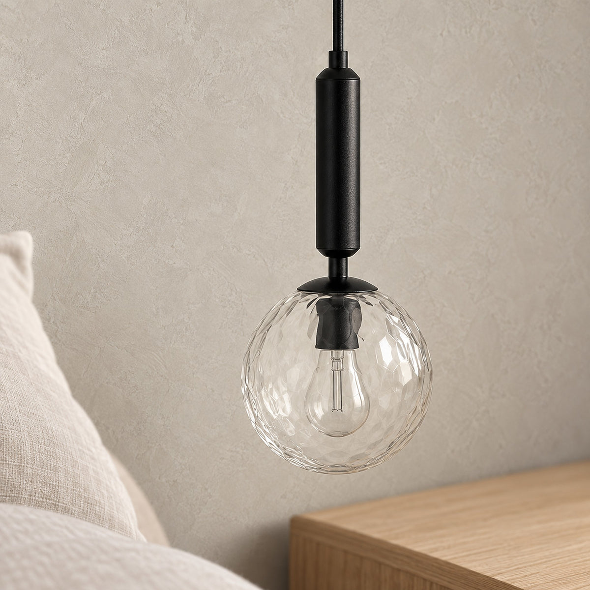 Orlamen black wall light up close and unlit, showing the clear glass globe and the bulb inside