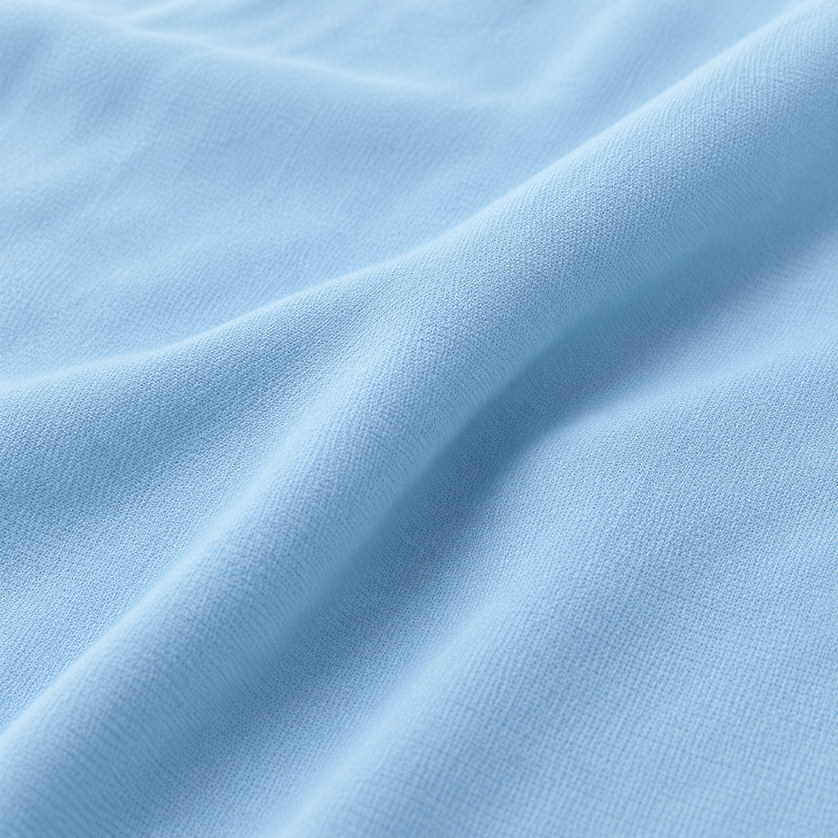 Ormivel sky blue knit throw blanket in close up showing the surface texture and a shallow fold