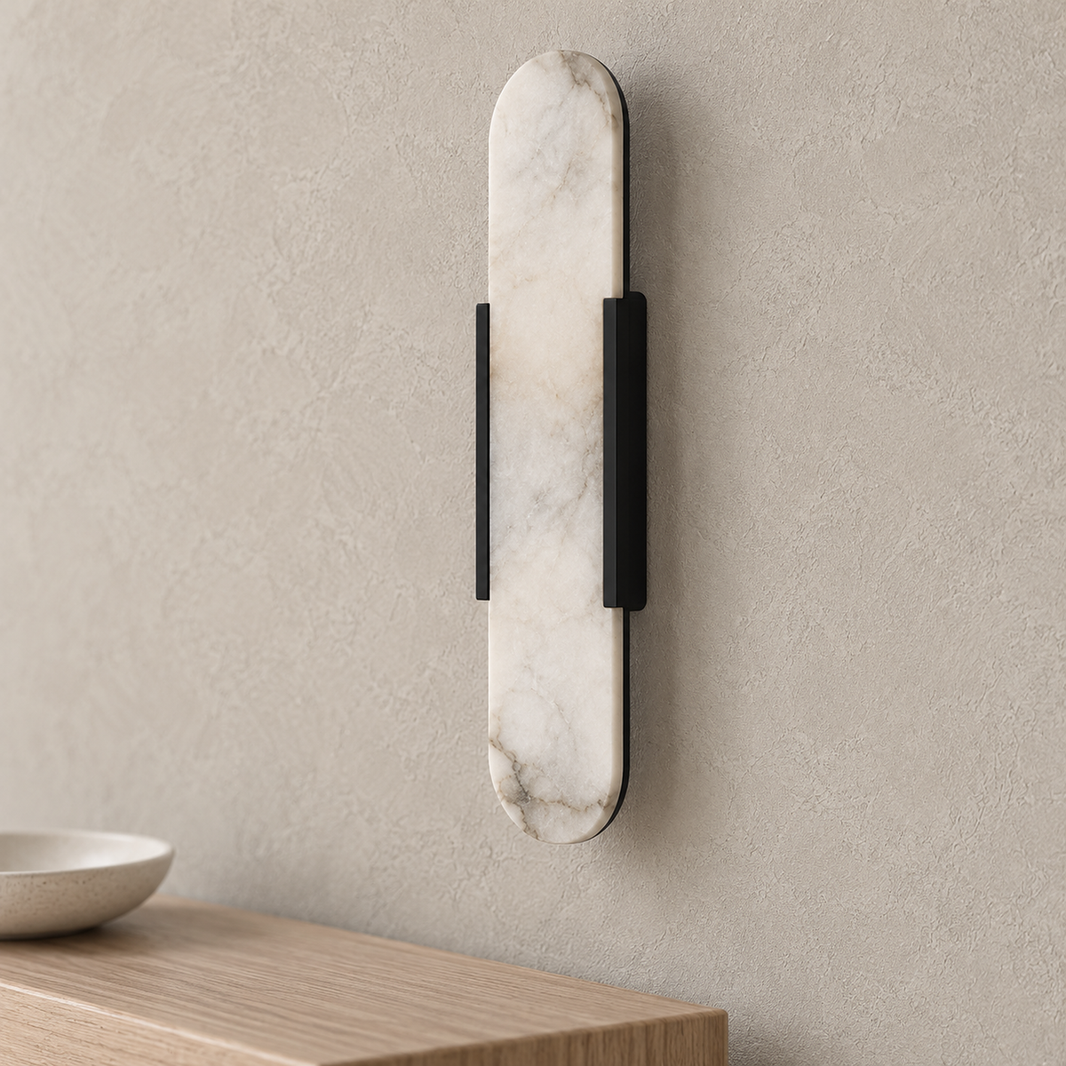 Oselira black wall light up close, showing natural marble veining and black metal bands