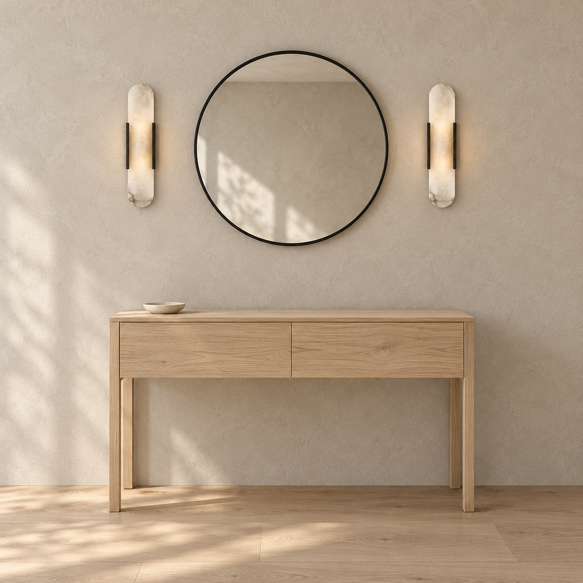 Oselira black wall sconce pair glowing beside a round entryway mirror above a console table