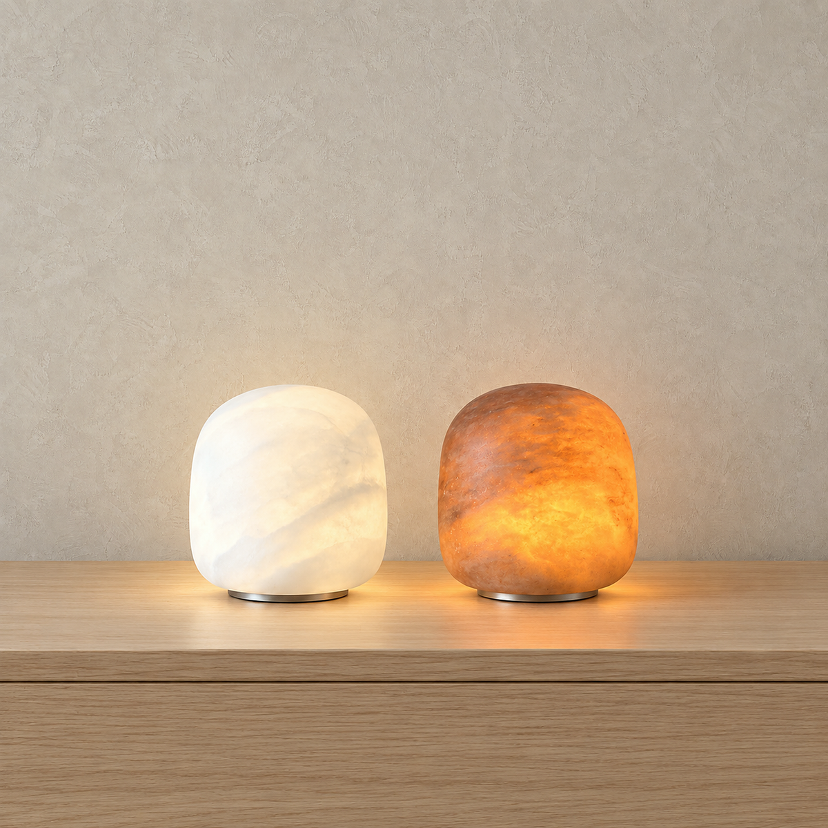 Ravelmo white and amber rechargeable table lamps lit side by side, soft neutral beside warm glow