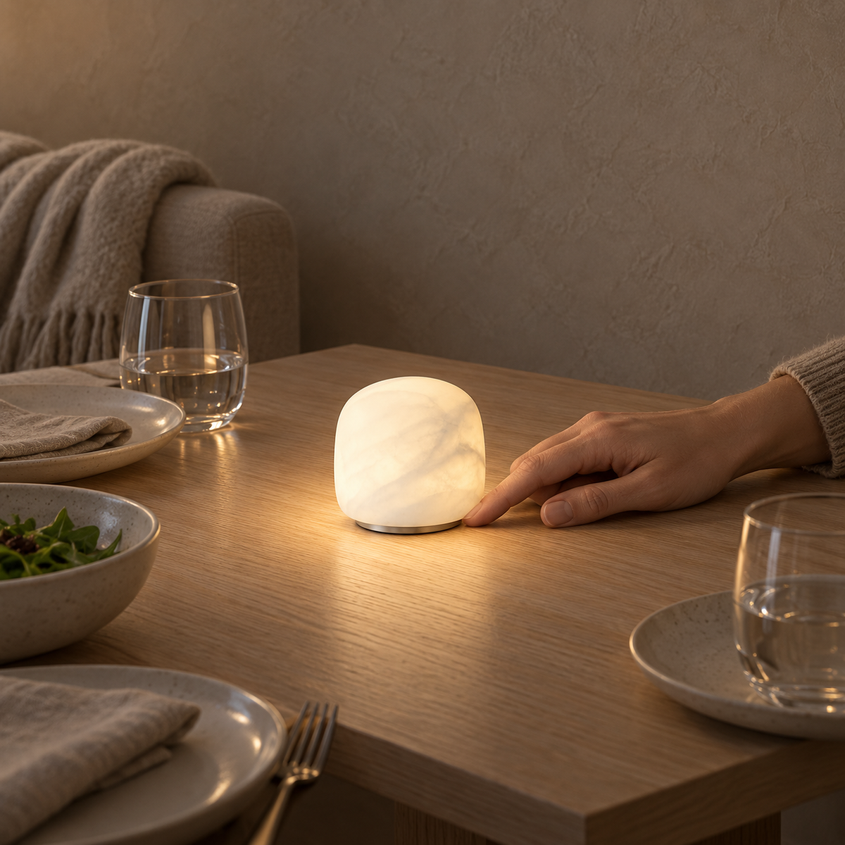 Ravelmo white portable table lamp glowing on a dining table in place of a candle