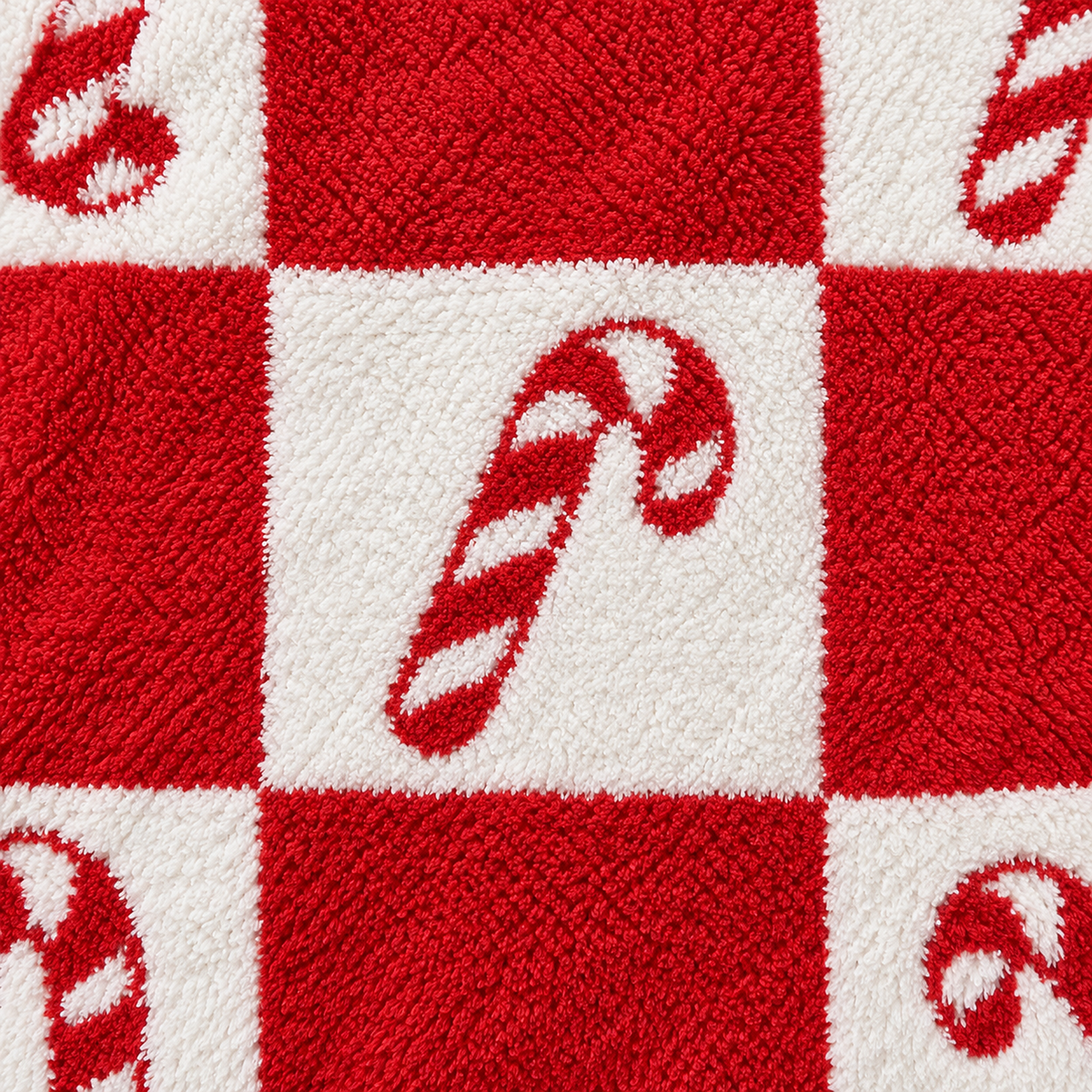 Remilta checkered candy cane plush throw blanket in a close view of its red and white candy cane surface