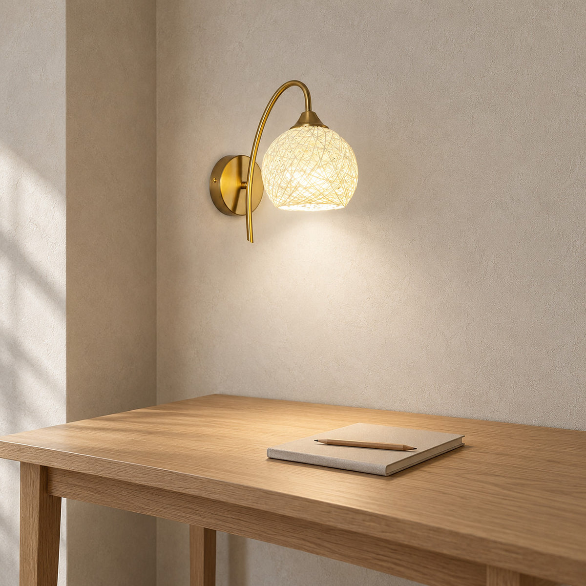Remilvo gold wall light giving neutral white light to a quiet study during the day