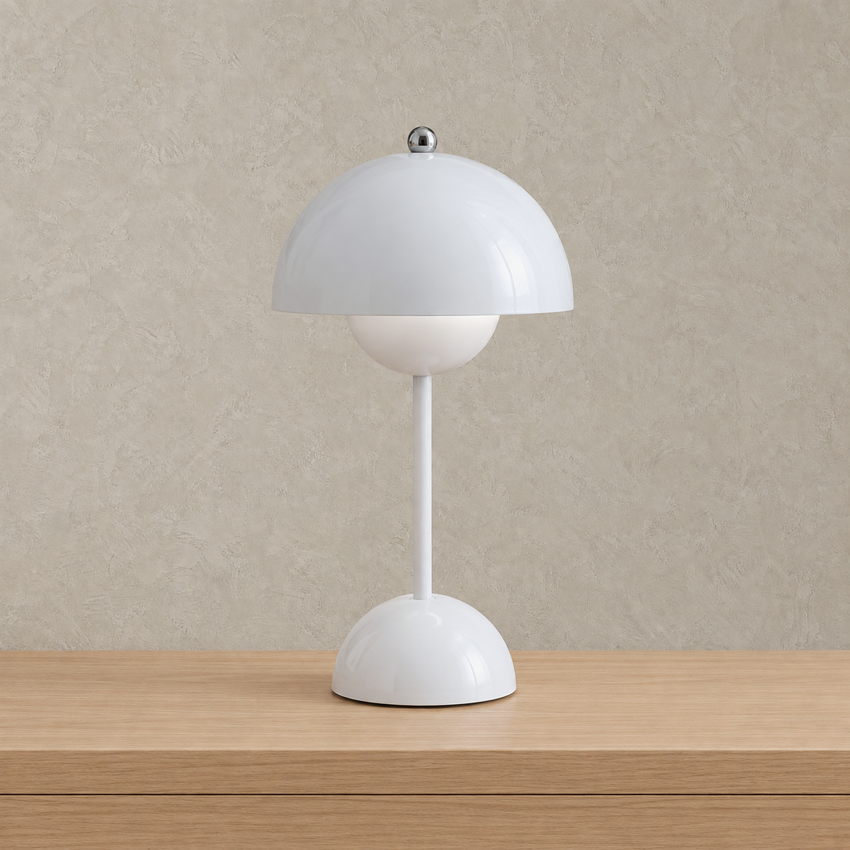 Retomira white rechargeable table lamp unlit against a plain plaster wall