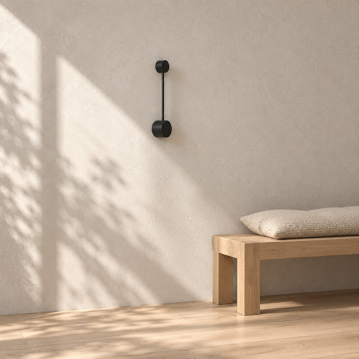 Rilameo black hardwired wall sconce unlit in direct daylight on an entry vestibule wall