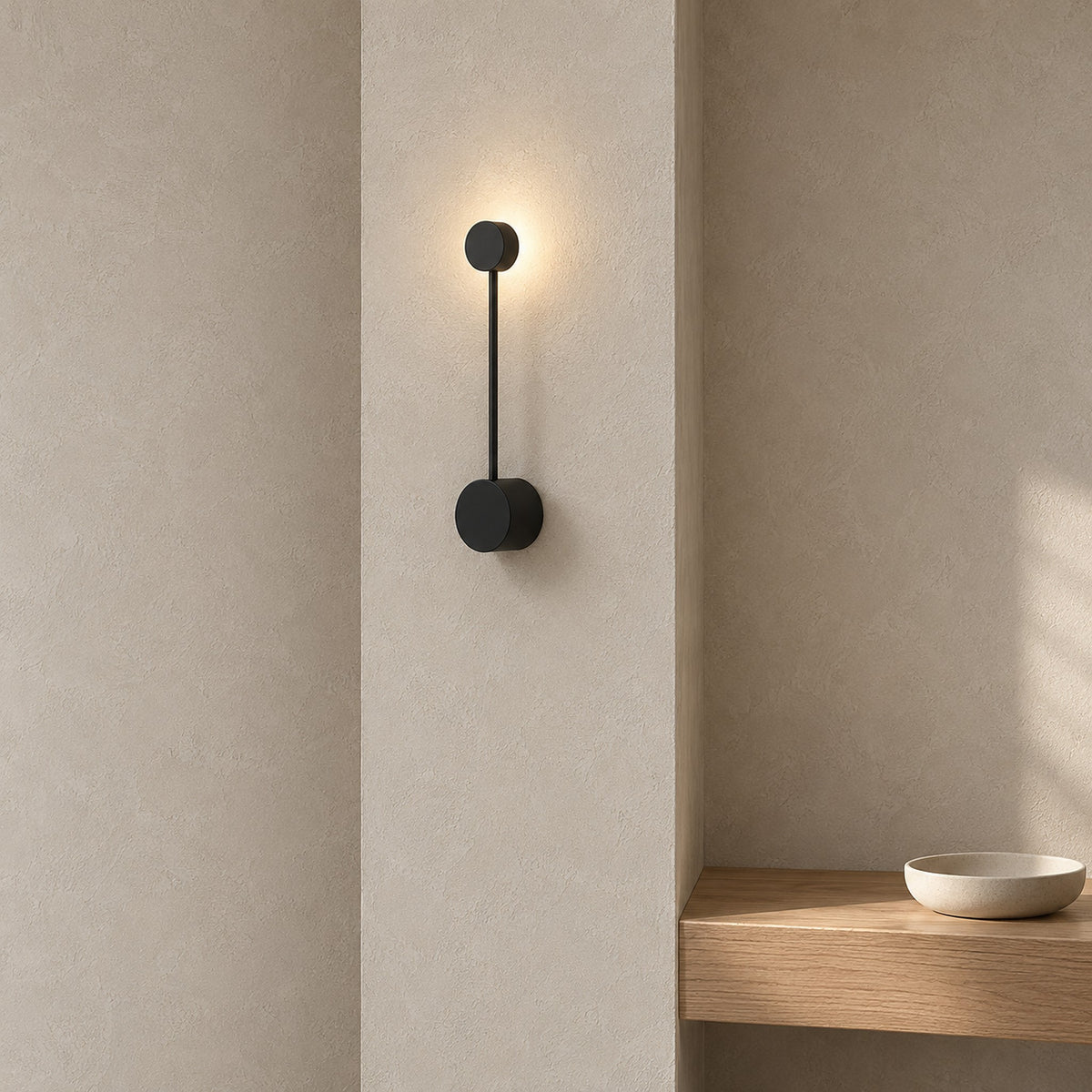 Rilameo black wall lamp lit on a narrow entry wall in a bright vestibule
