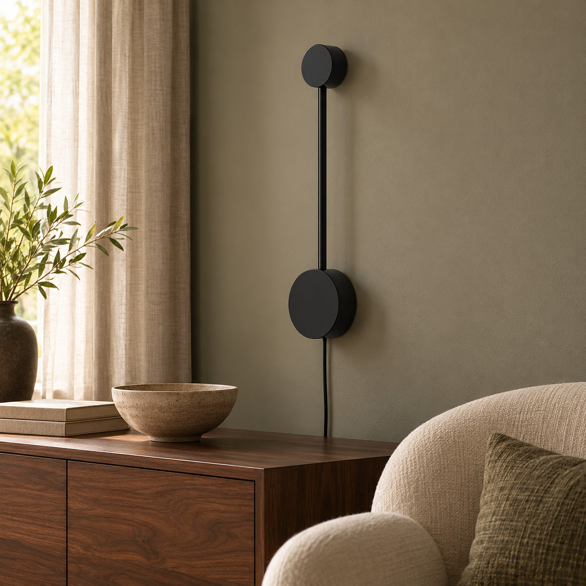 Rilameo plug in led wall sconce in black iron with its power cord running down the wall