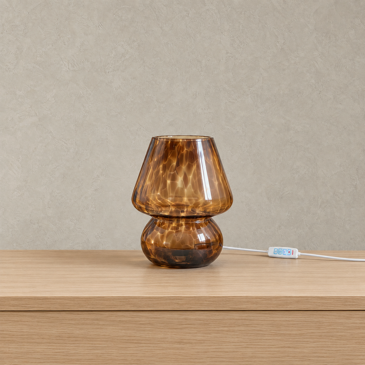 Rimelota brown mushroom table lamp shown unlit with its glass body and speckled glass shade on a plain backdrop