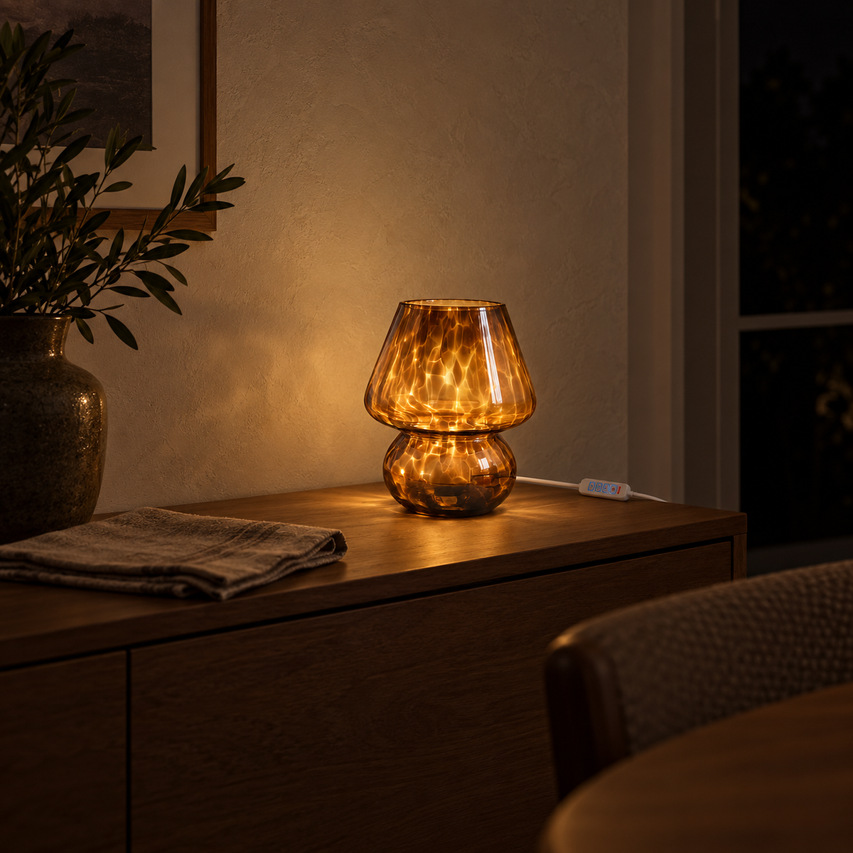 Rimelota brown table lamp dimmed to a softer warm glow on a dining table in the evening