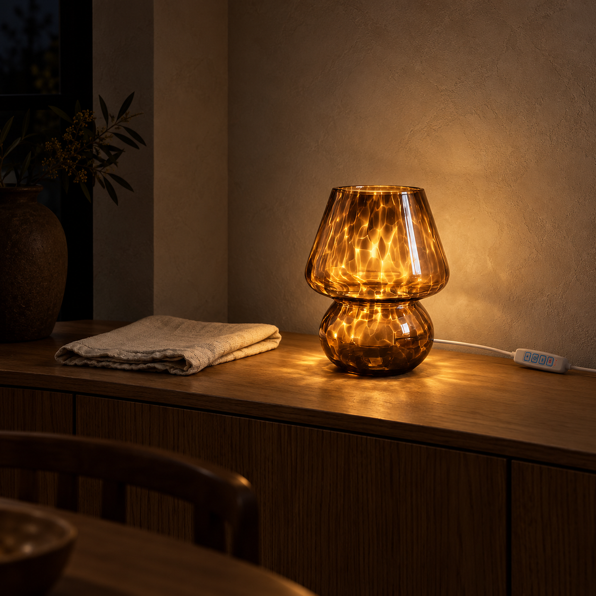 Rimelota brown table lamp on a brighter warm setting casting pools of light on a dining table at night