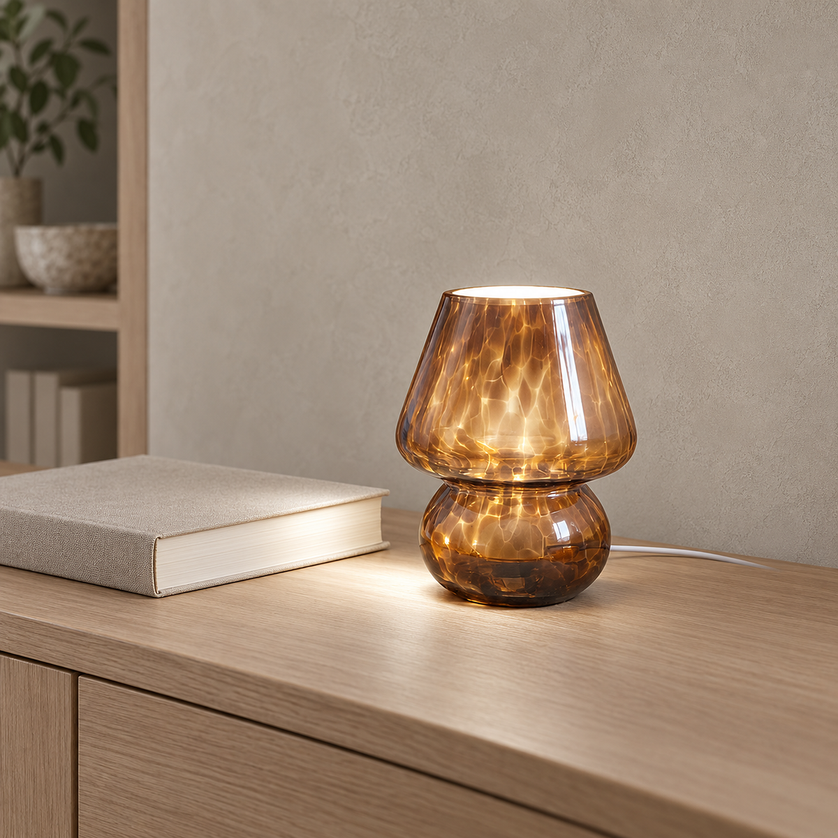 Rimelota brown table lamp set to a whiter color temperature beside a plain book in a library