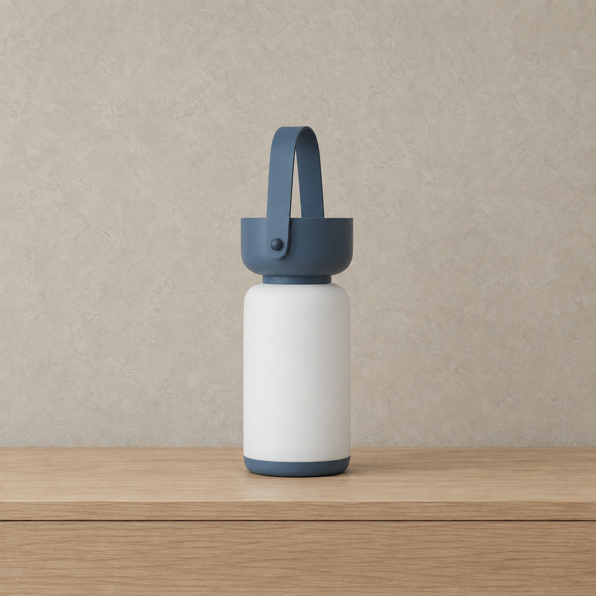 Ronalise blue cordless table lamp unlit with its loop handle raised on a plain plate