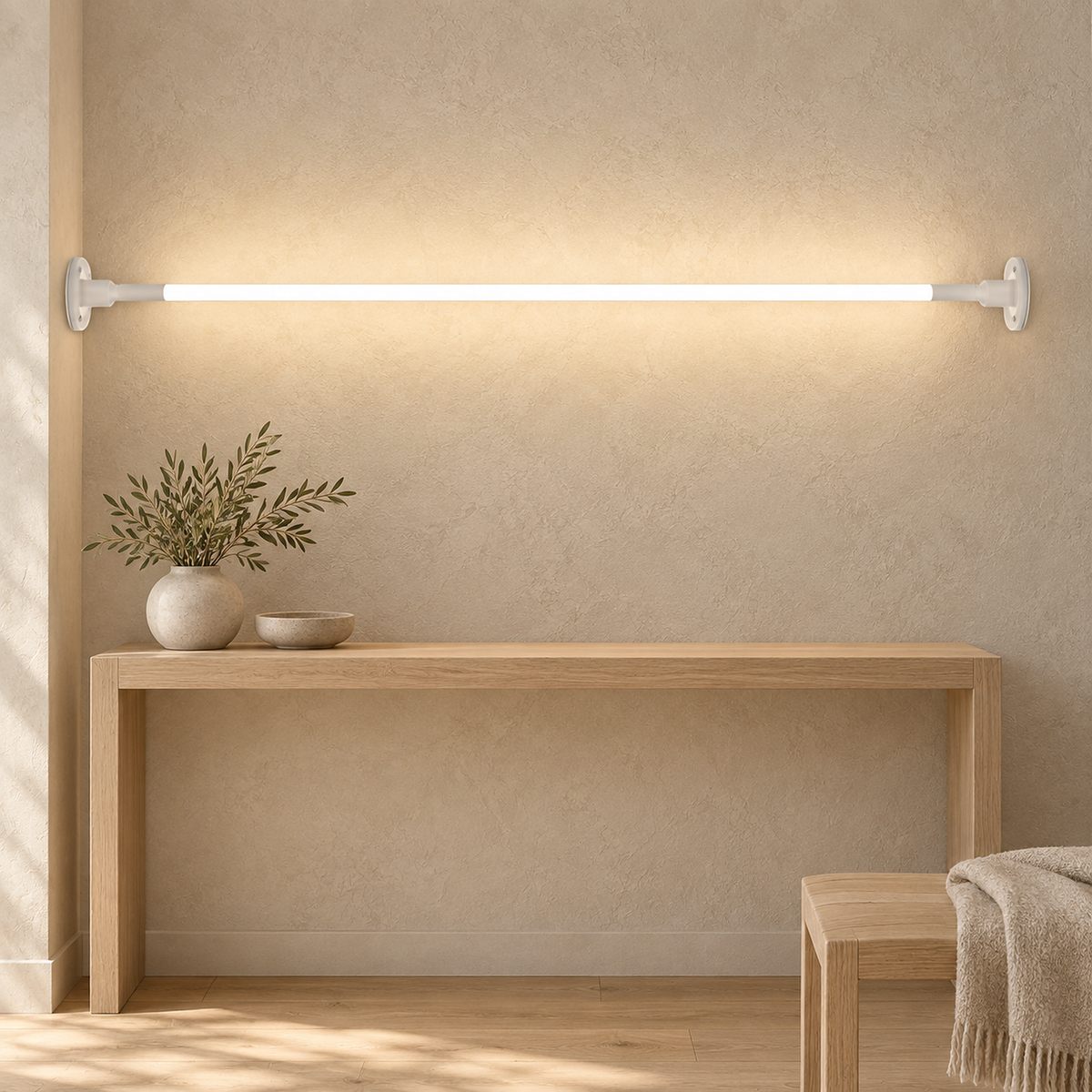 Ronelia white LED wall sconce washing plaster above a console table in daytime light