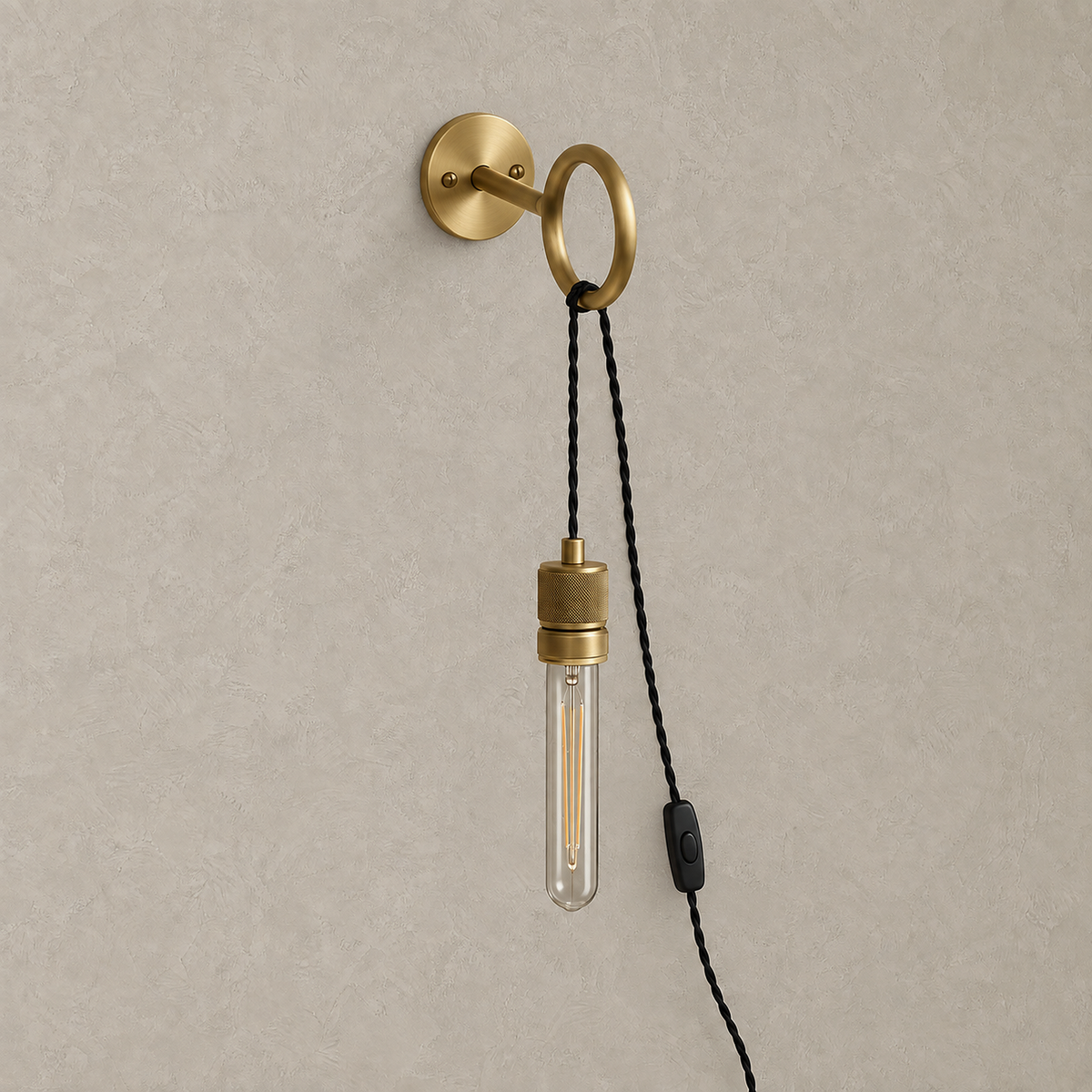 Rovenila gold wall sconce shown unlit with its exposed bulb and plated metal ring