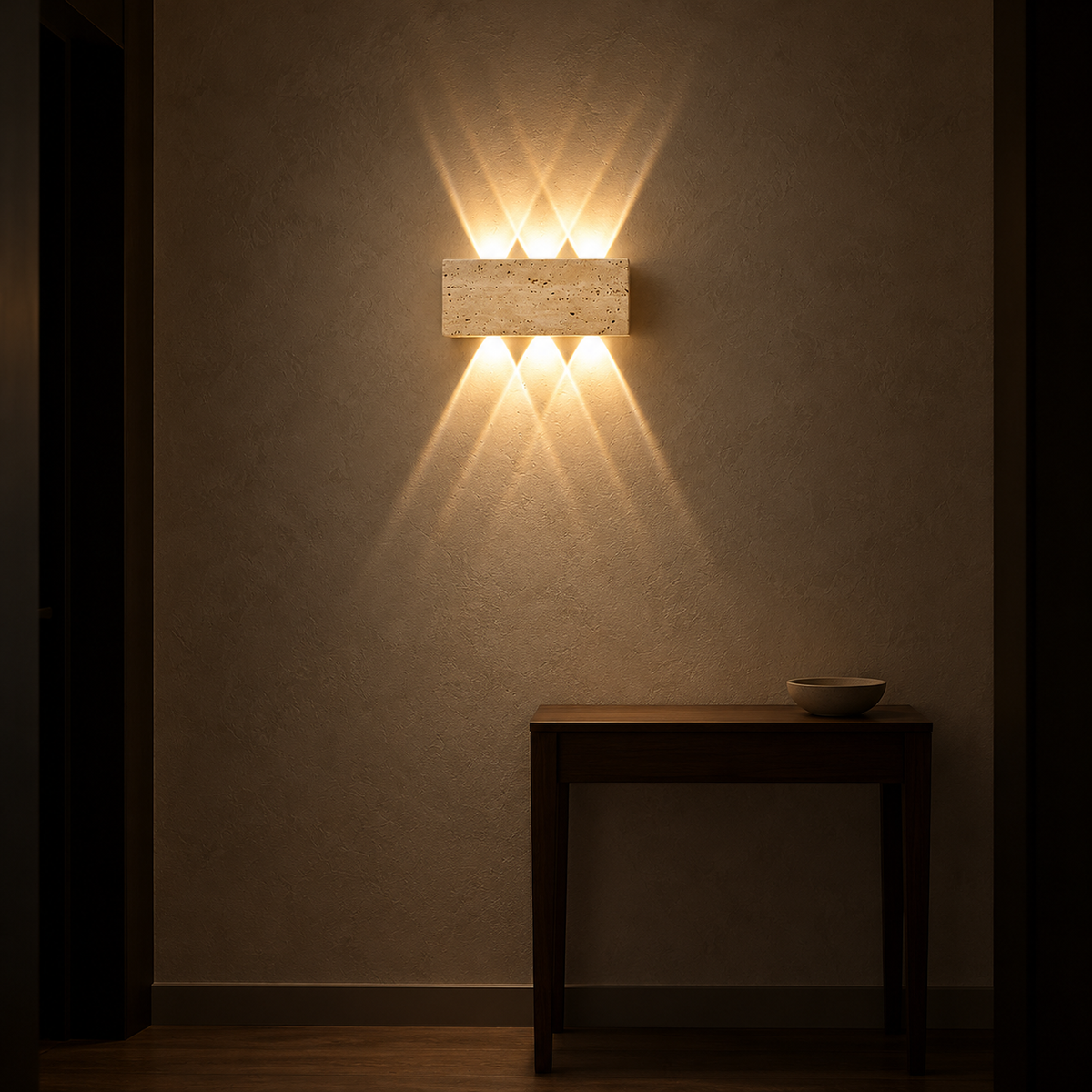 Sarivol beige stone LED wall sconce at night, warm light drawing diamonds along a hallway wall