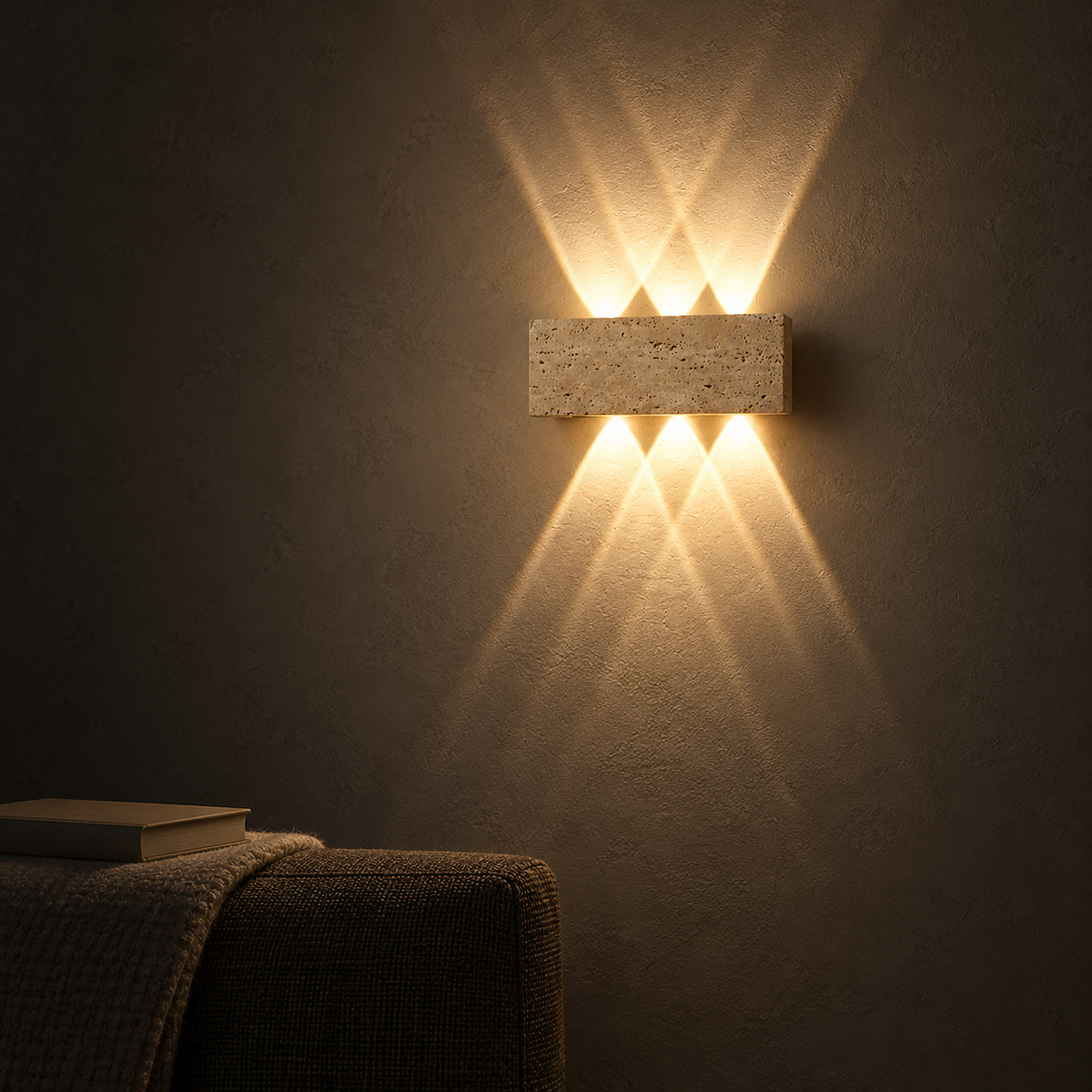 Sarivol beige stone wall light at night sending warm beams up and down the wall above a sofa