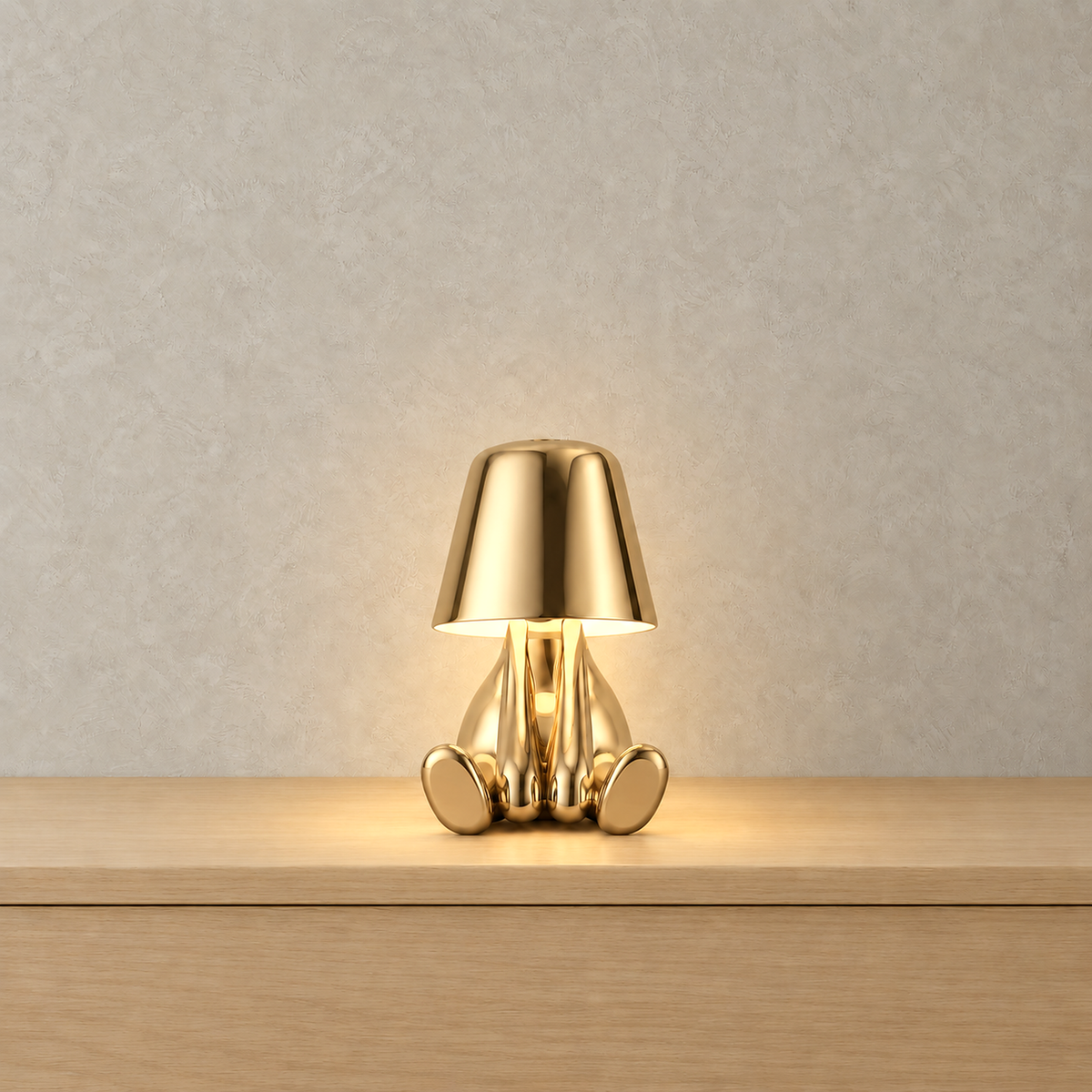 Sarovel gold rechargeable table lamp switched on and glowing softly from beneath its own shade