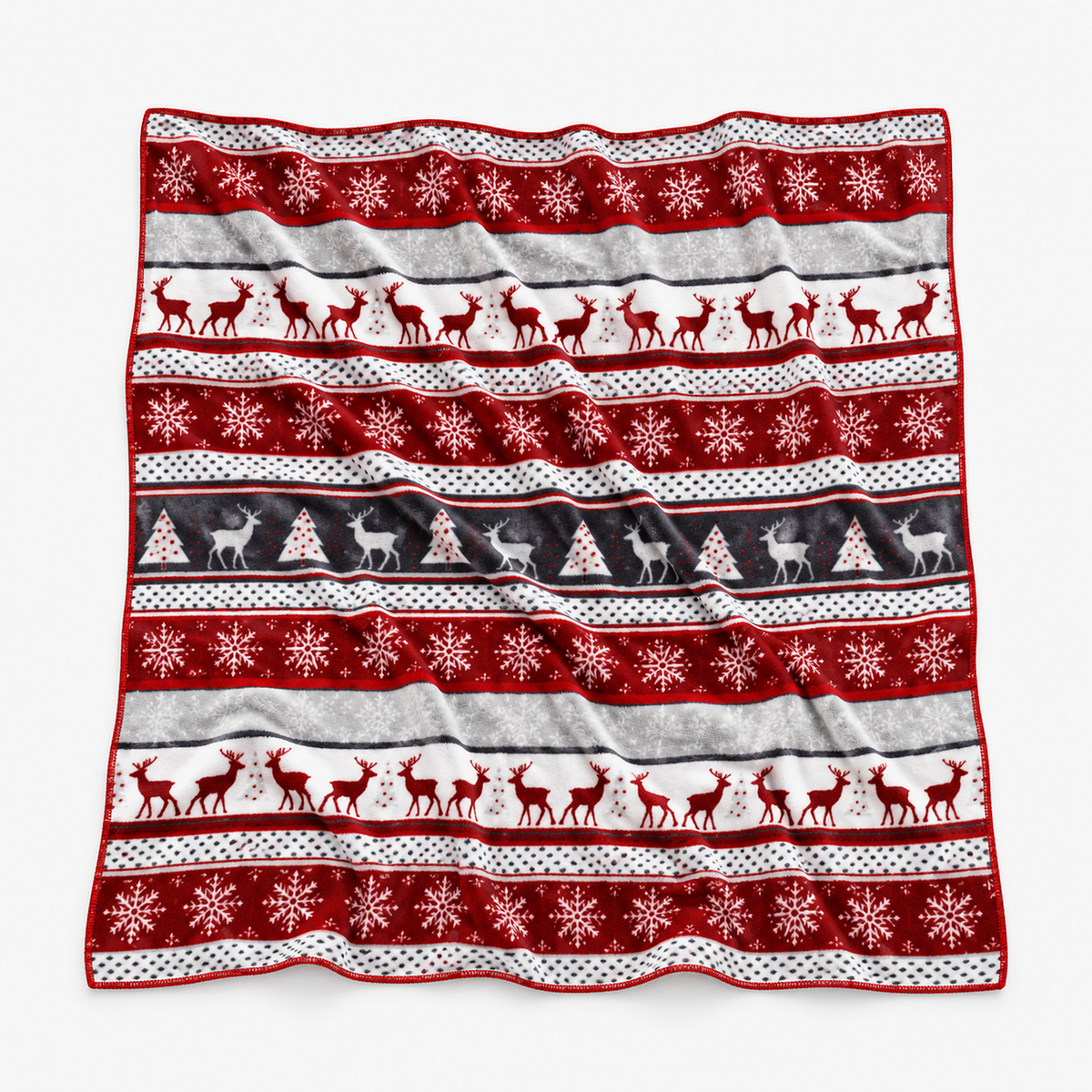 Savelmi christmas flannel throw blanket in red and white laid fully open with rows of reindeer, trees and snowflakes