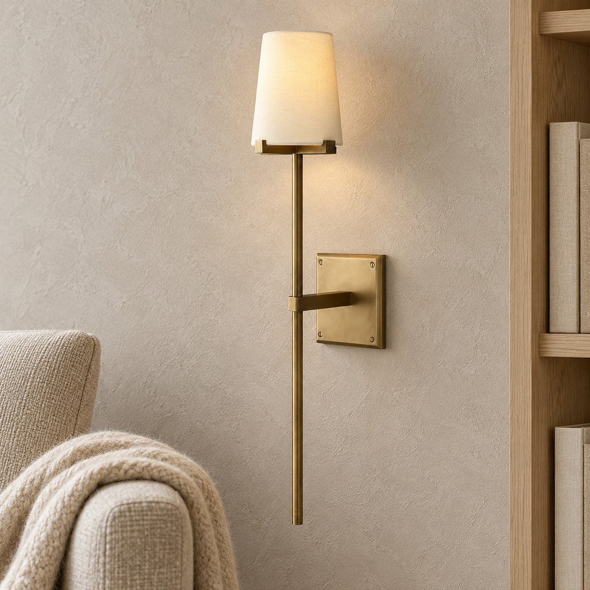 Savorel copper colored wall light with a glowing fabric shade beside library seating in daylight