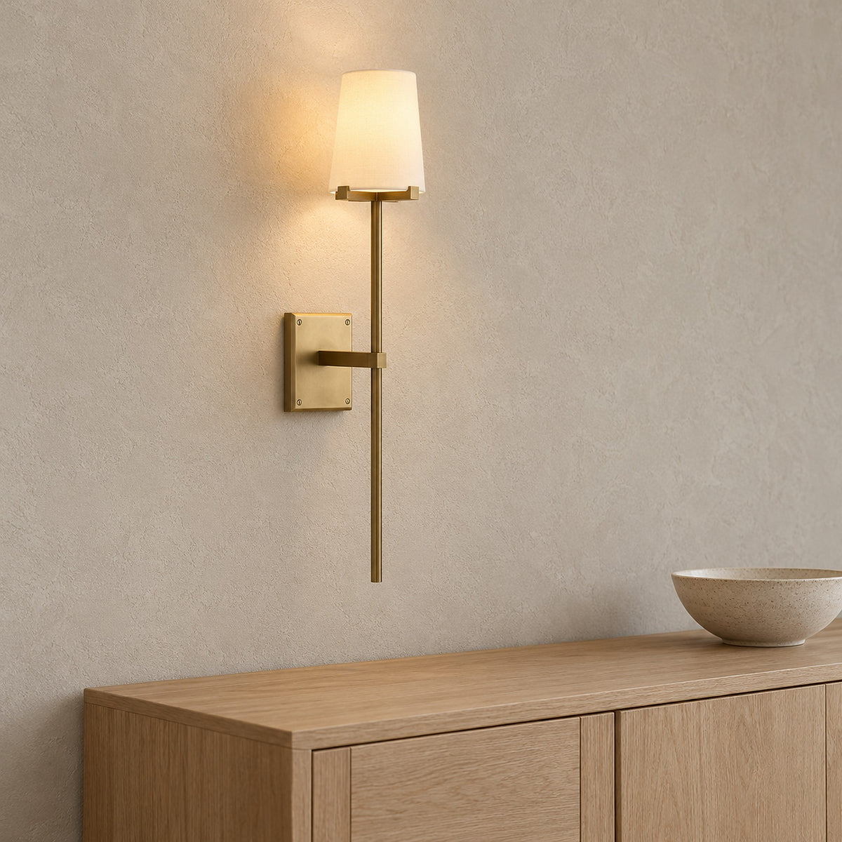 Savorel copper colored wall sconce, detail of the backplate and short support arm in a dining room
