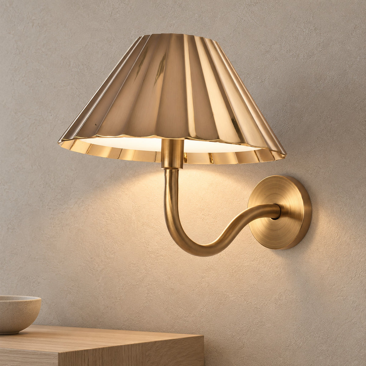 Selorna gold LED wall sconce lighting an entryway wall in daytime
